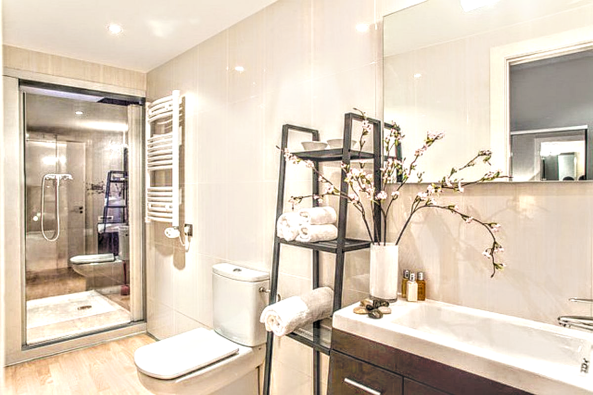 the "safari lodge" ensuite bathroom with cabin shower and electric radiator at the Parsifal apartment for rent monthly in Barcelona